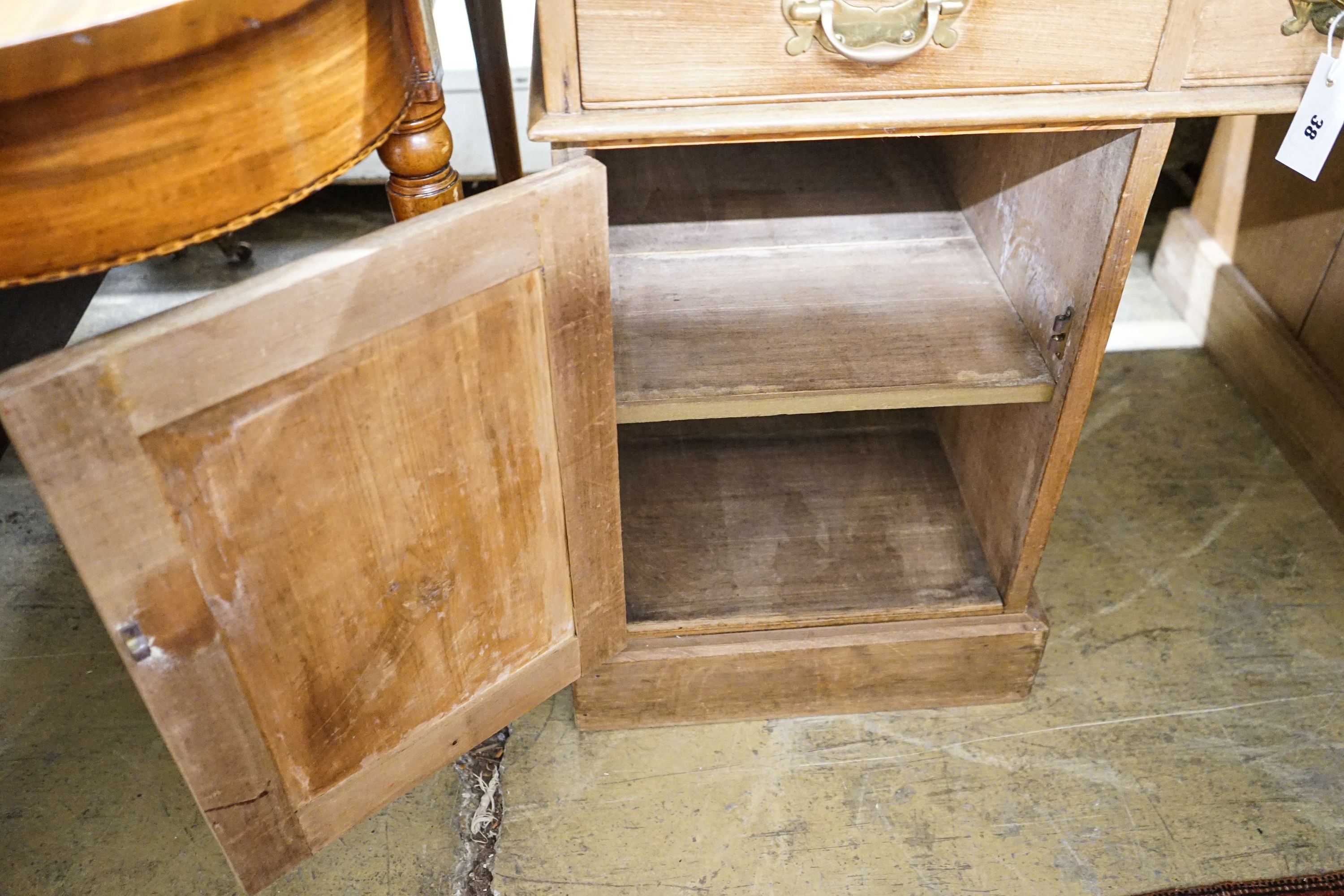 An Edwardian stripped beech pedestal desk, fitted eleven drawers, width 138cm, depth 80cm, height 76cm